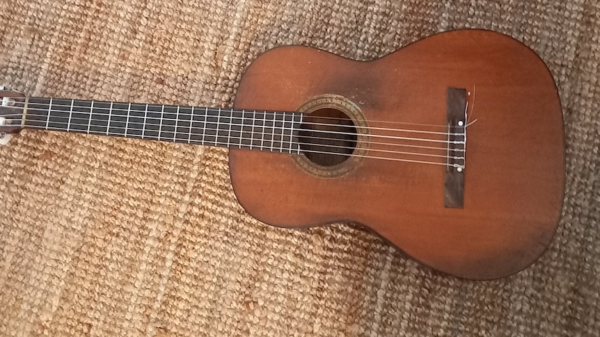 a slightly worn and aged acoustic guitar
