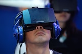 A man wears a Oculus Rift HD virtual reality headset