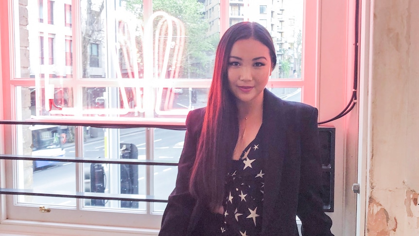 Sharon Jiang, an Asian woman with long hair sitting down.