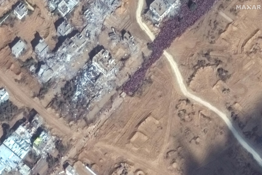 satellite image that shows a massive hoard of people densely packed on a road