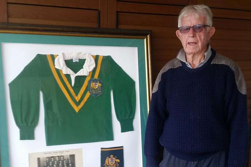 Ken McCaffery poses with his framed Australian Rugby League jumper.