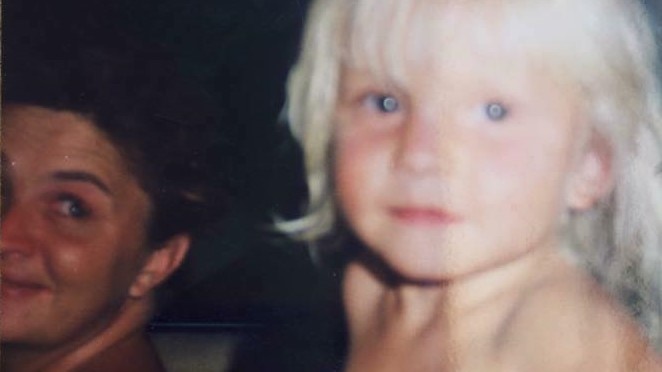 A family photo of three-year-old Courtney Ugle sitting in a car with her mother.