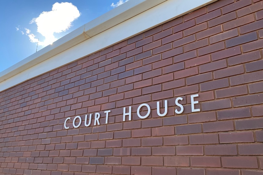 A brick building with "court house" written on the front in silver lettering.