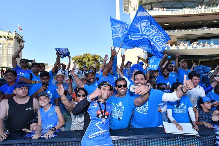 The Adelaide Strikers' Alex Carey celebrates with fans after winning the Big Bash final