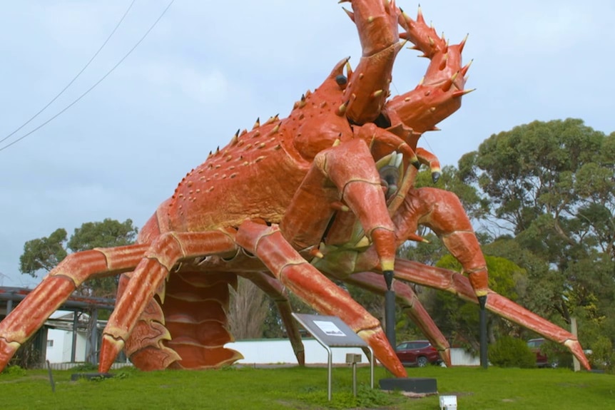 A giant lobster statue sits on the grass