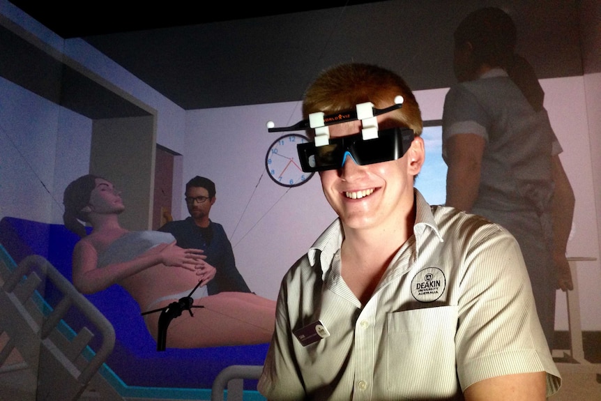 A midwifery student, in the virtual reality lab wearing special glasses.