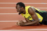 Jamaica's Usain Bolt lies on the track after injuring himself.