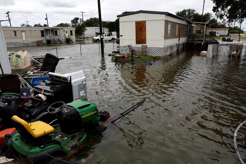 A flooded street outside a home after heavy storm activity