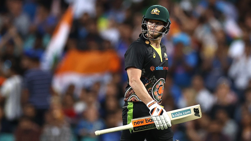 Cricket player walking off the pitch during a match