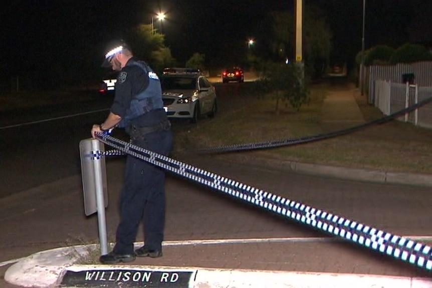 A police officer cordons off Willison Road.
