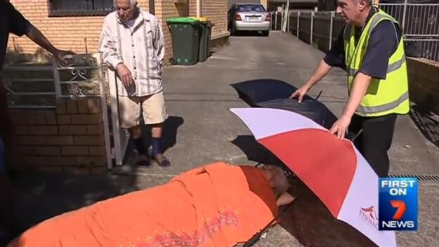 Elderly Sydney woman lies on footpath waiting for ambulance