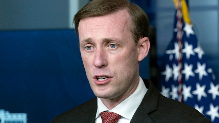 National Security Adviser Jake Sullivan speaks in front of a US flag.