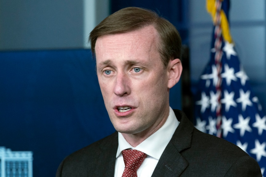 National Security Adviser Jake Sullivan speaks in front of a US flag.