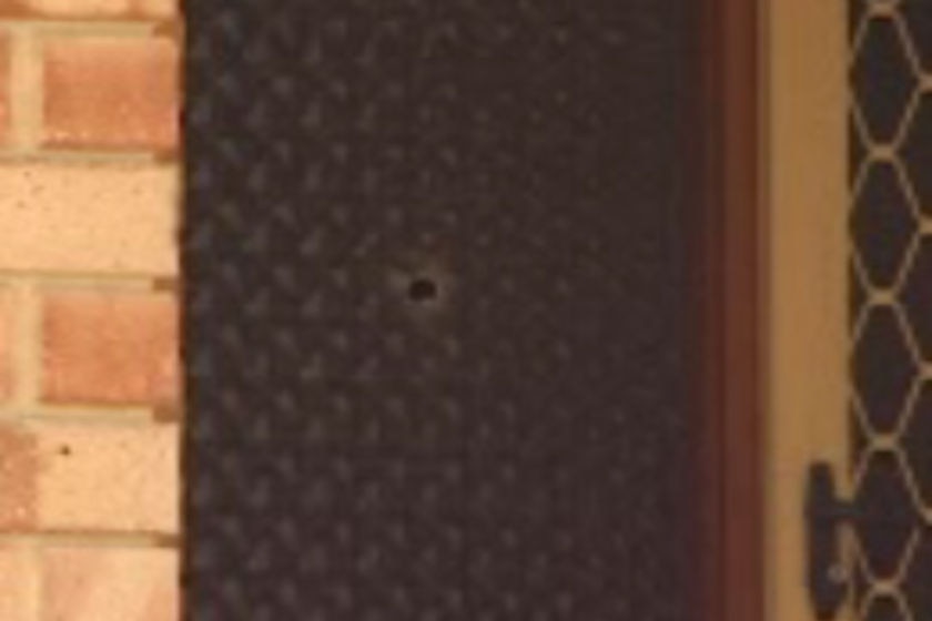 A bullet hole through the door of a Kingsley home