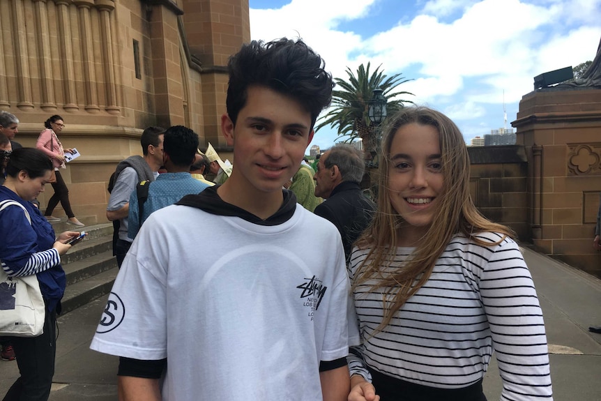 A young man and woman outside the church.