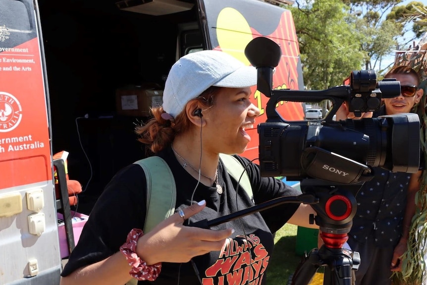 Young girl holding camera