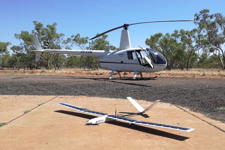 Solar powered drone in front of helicopter