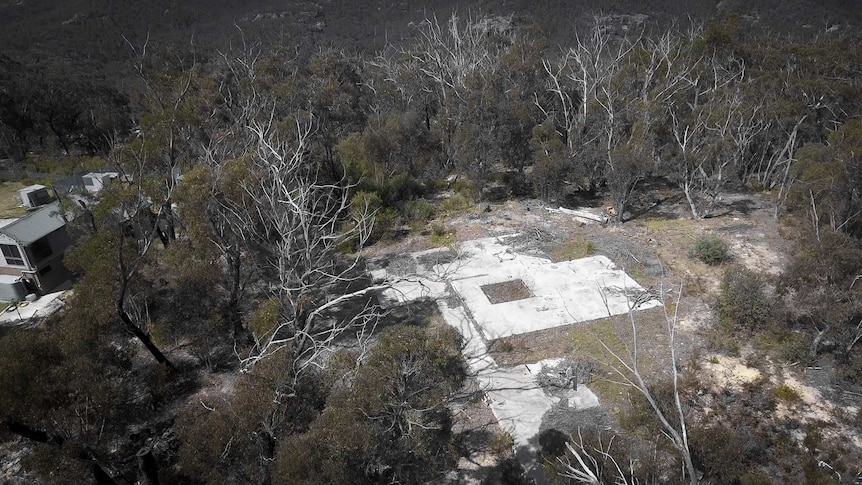 To the left is the new home build on the site of Simon Crosbie's old house, and to the right is a charred empty block.