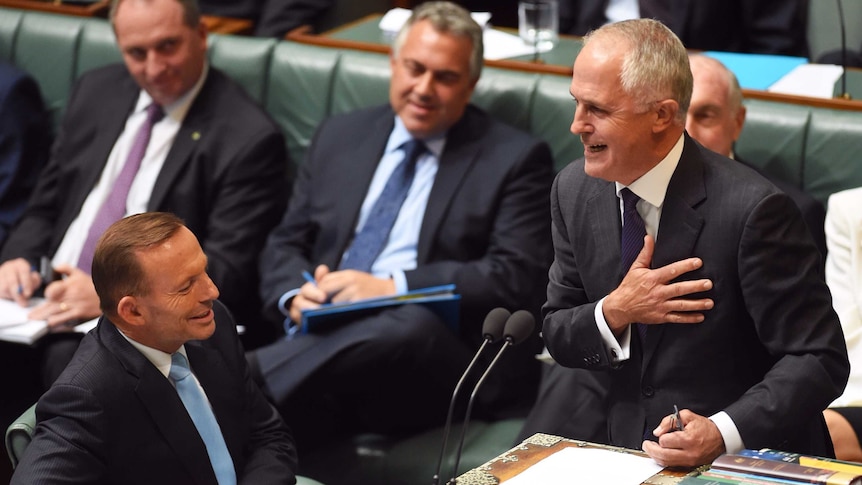 Malcolm Turnbull speaks as Tony Abbott looks on during Question Time