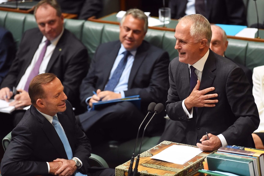 Malcolm Turnbull speaks as Tony Abbott looks on during Question Time