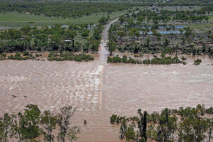 The Burdekin River over Hervey's Range Road just outside Townsville on Wednesday.