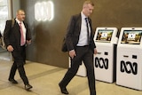 Two men in suits enter the ABC.