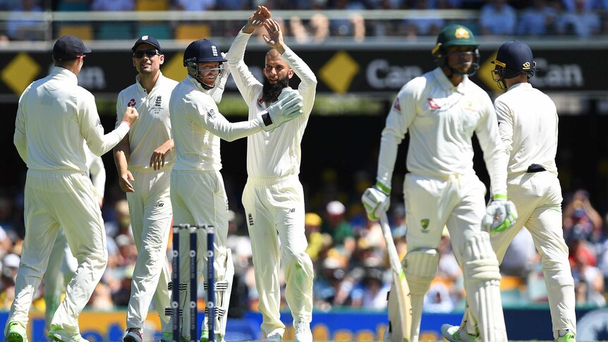 England celebrate the wicket of Usman Khawaja on day two at the Gabba.