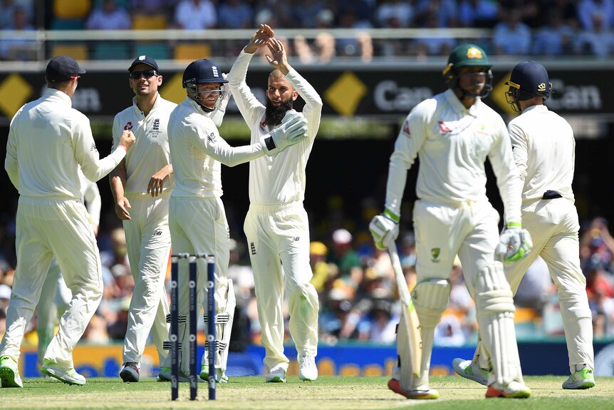 England celebrate the wicket of Usman Khawaja on day two at the Gabba.