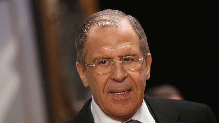 Head and shoulders of Russian Foreign Minister Sergey Lavrov wearing a dark suit and purple tie