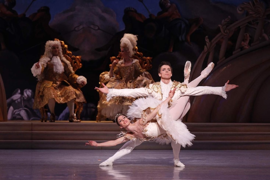 Lana Jones and Kevin Jackson, dressed in white, perform on stage in The Sleeping Beauty at the Sydney Opera House.