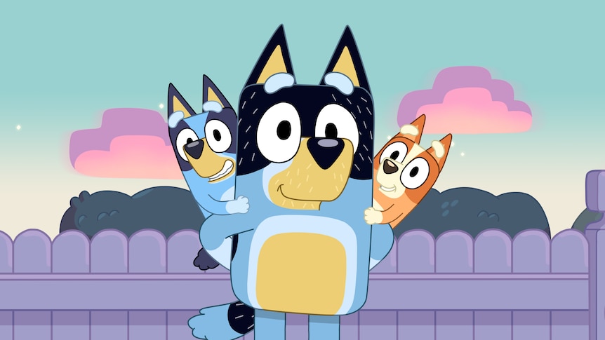 Bandit stands smiling with Bluey and Bingo sitting on his shoulders.