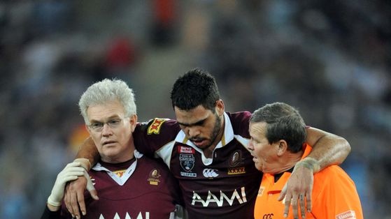 Qld's Greg Inglis is helped from the field after being injured during State of Origin II
