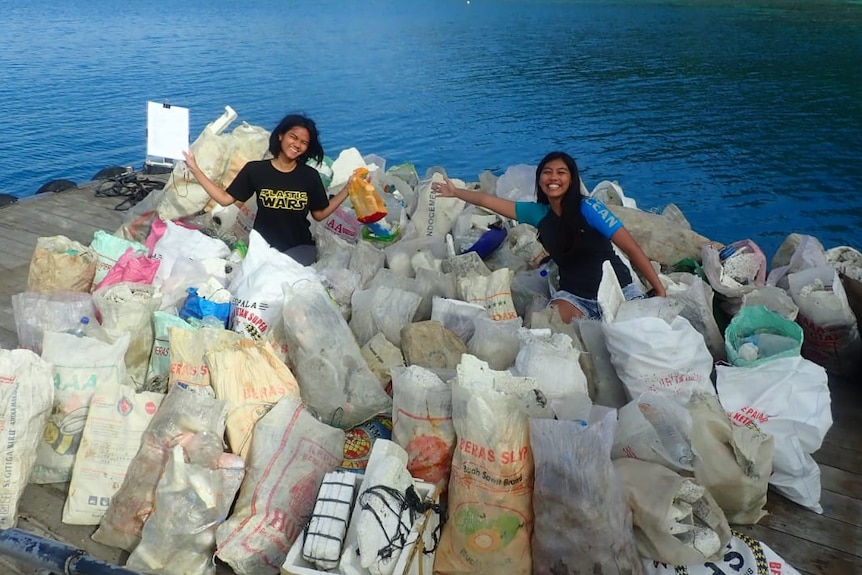 Two women with the pile of rubbish