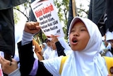 A young Indonesian female in a street protest in Jakarta