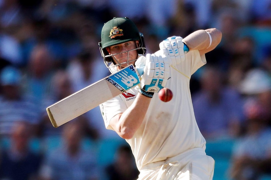 Steve Smith plays a ball with a horizontal bat just under his eye line