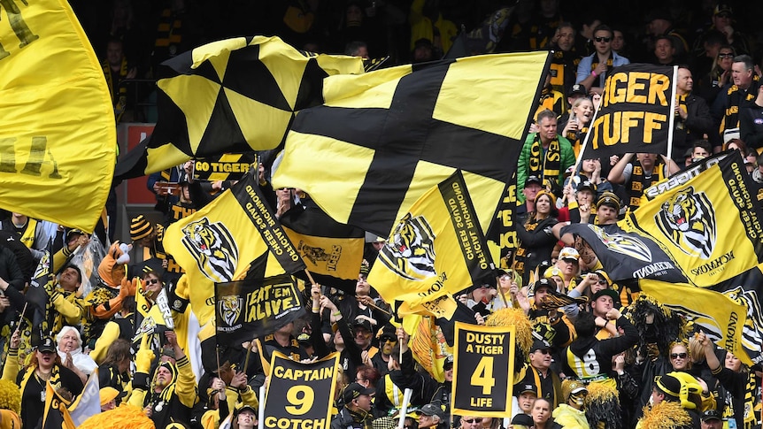 Tigers fans wave flags at the MCG in Melbourne.