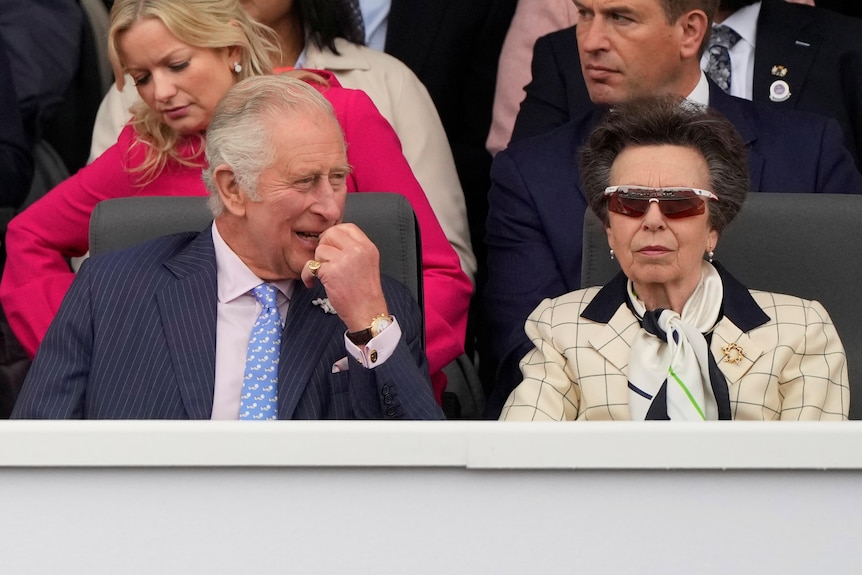 King Charles and his sister Princess Anne sit next to each other