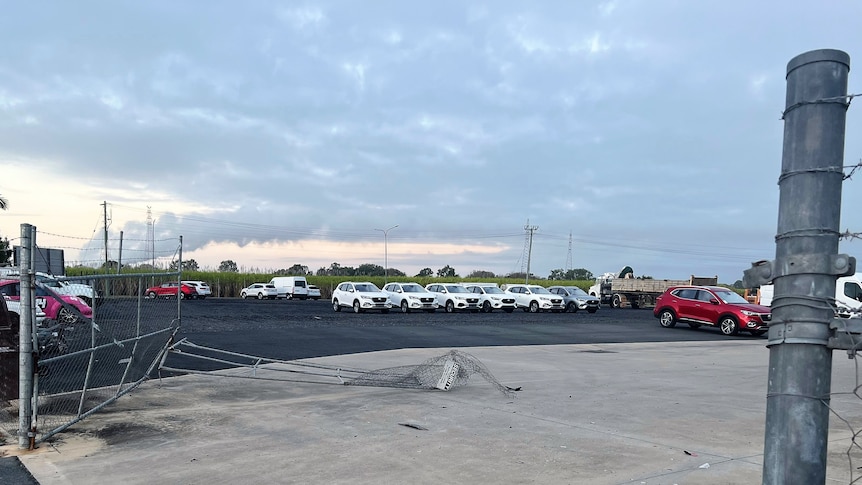 A new car yard with security gates broken down after a ram raid.