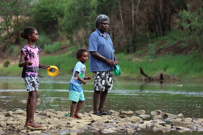 Keith Rory from Borroloola fishes at the McArthur River with his 10-year-old daughter Rashiya 10 and five-year-old son Gershom.