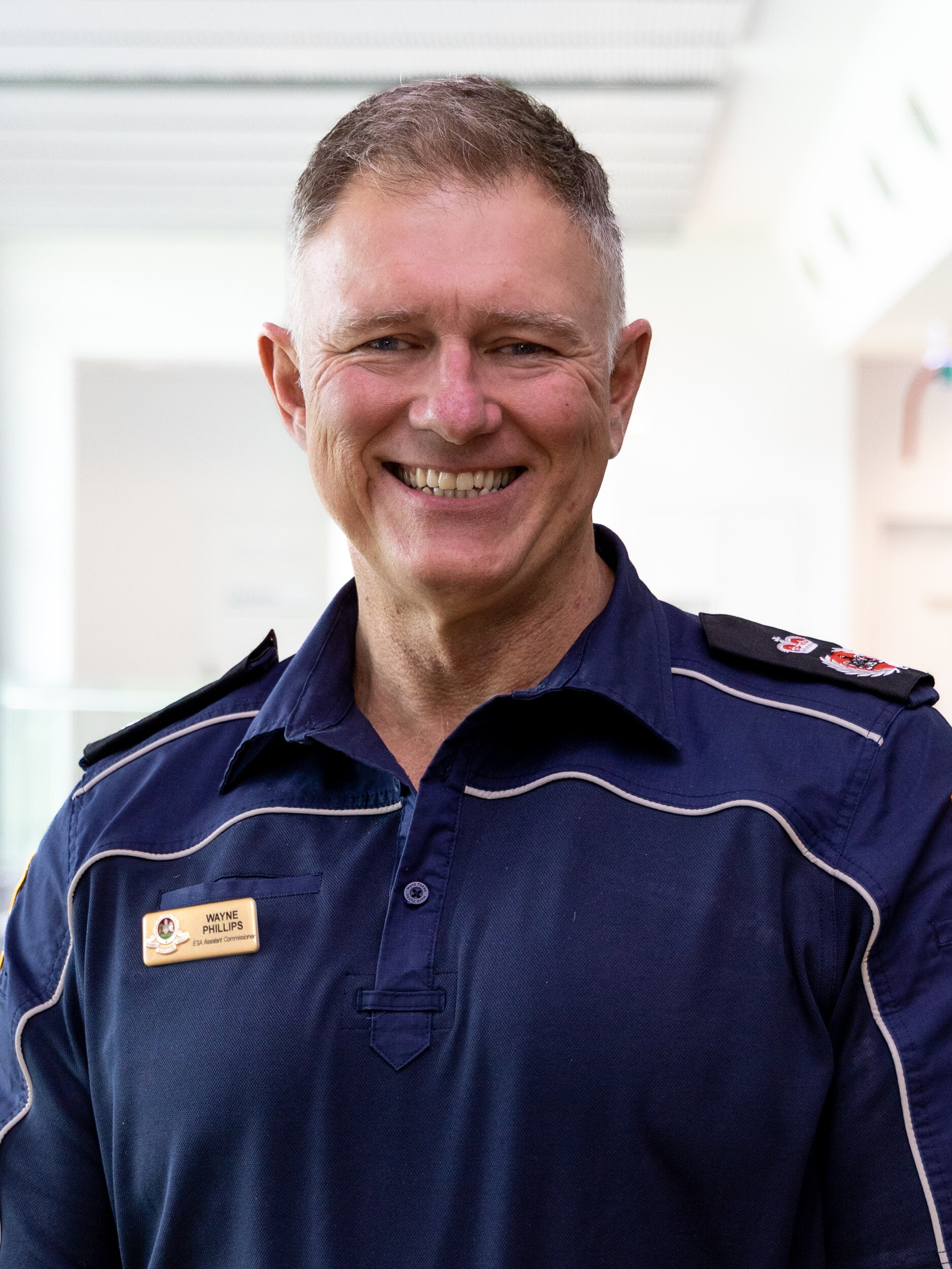 Man smiling wearing a blue ESA shirt