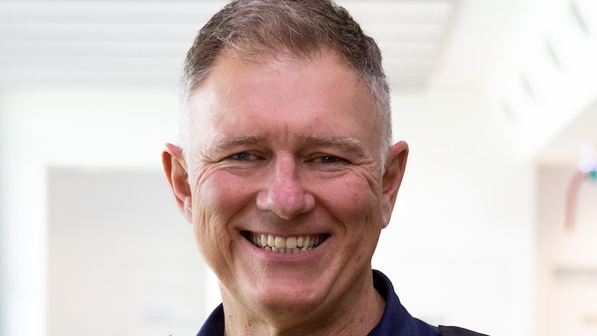 Man smiling wearing a blue ESA shirt