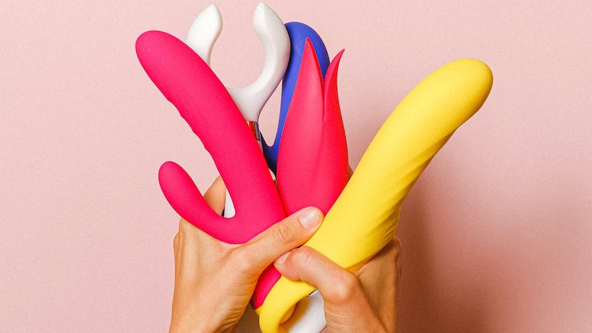 a hand holding sex toys