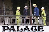 Queensland fire authorities inspect the top floor verandah of the Palace Backpackers Hostel