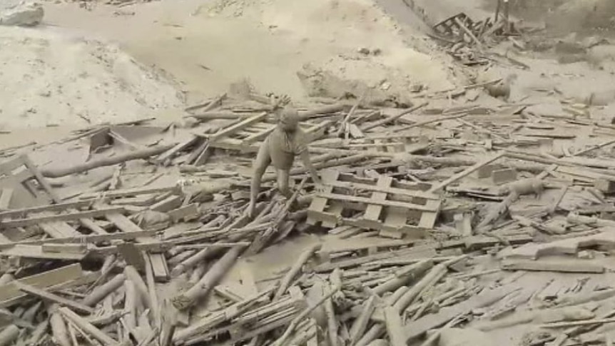 A woman filmed struggling free from a mudslide in Peru's capital, Lima.