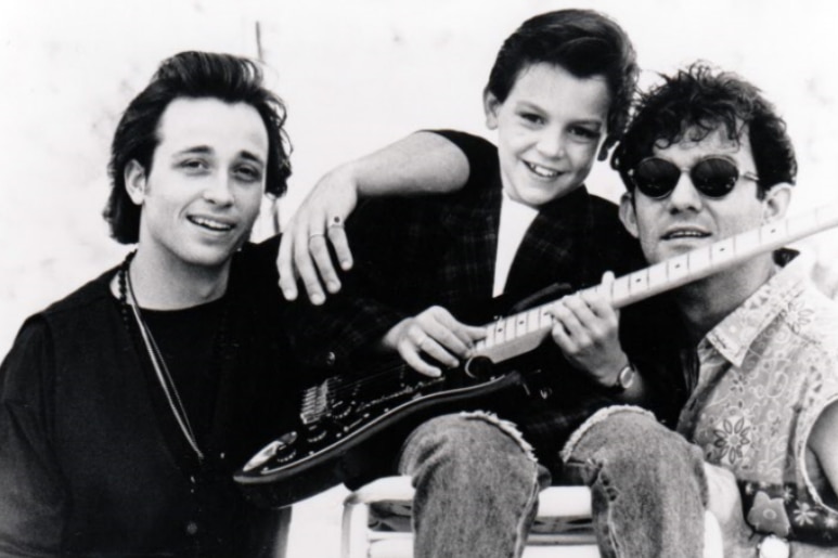 A black and white photo of Diesel and Jimmy Barnes with a young Nathan Cavaleri holding a guitar