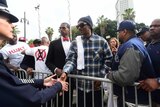 Rapper Snoop Dogg is greeted by a police officer