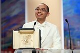 Thankful: director Apichatpong Weerasethakul poses for photos after winning the Palme d'Or