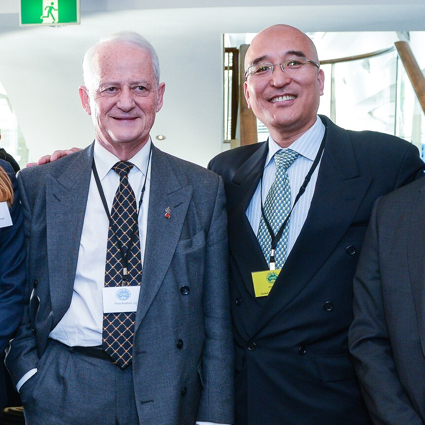 Jimmy puts arm around Philip Ruddock in a conference photo.