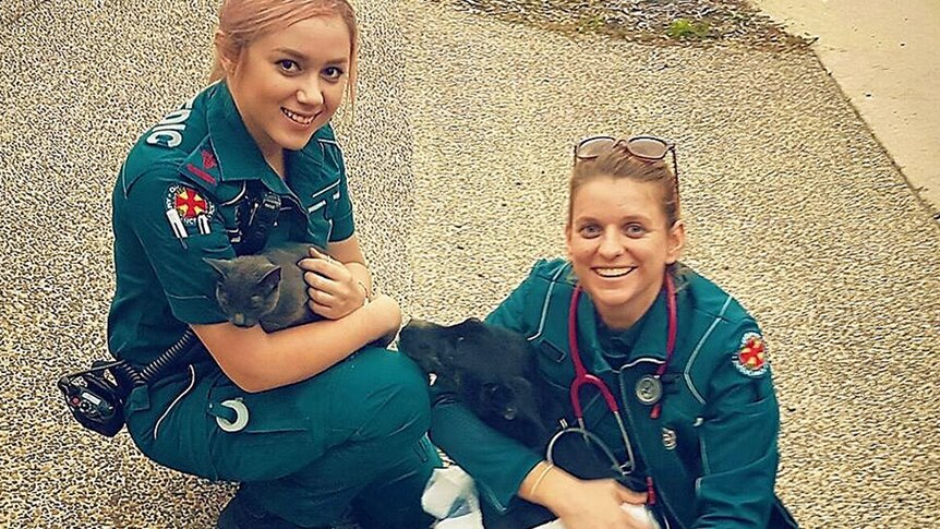 Ambulance officers Jenny Chesters and Shelley Pringle with rescued Holden and Chip