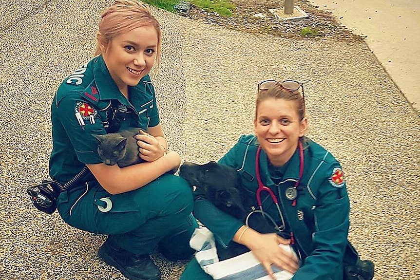 Ambulance officers Jenny Chesters and Shelley Pringle with rescued Holden and Chip